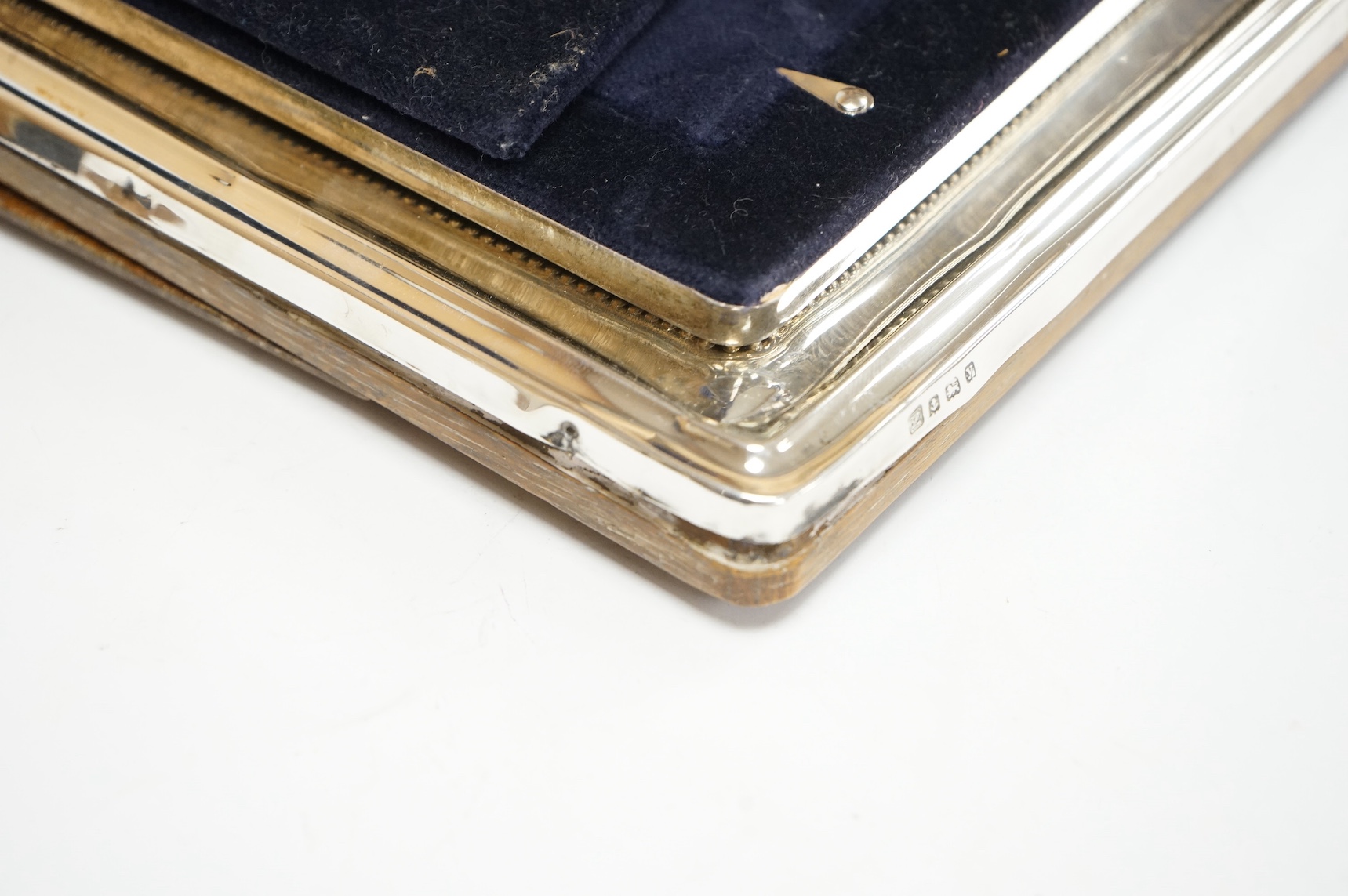A George V silver mounted photograph frame, by A & J Zimmerman, Birmingham, 1923, 25.7cm, one other modern silver mounted photograph frame and a cased set of six silver handled tea knives. Condition - poor to fair